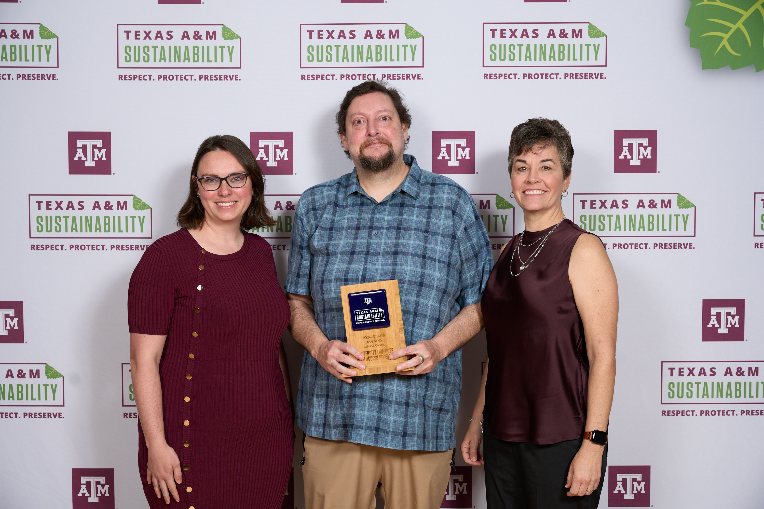 University Libraries accepting an award from Kelly Wellman and Danielle Laperriere.